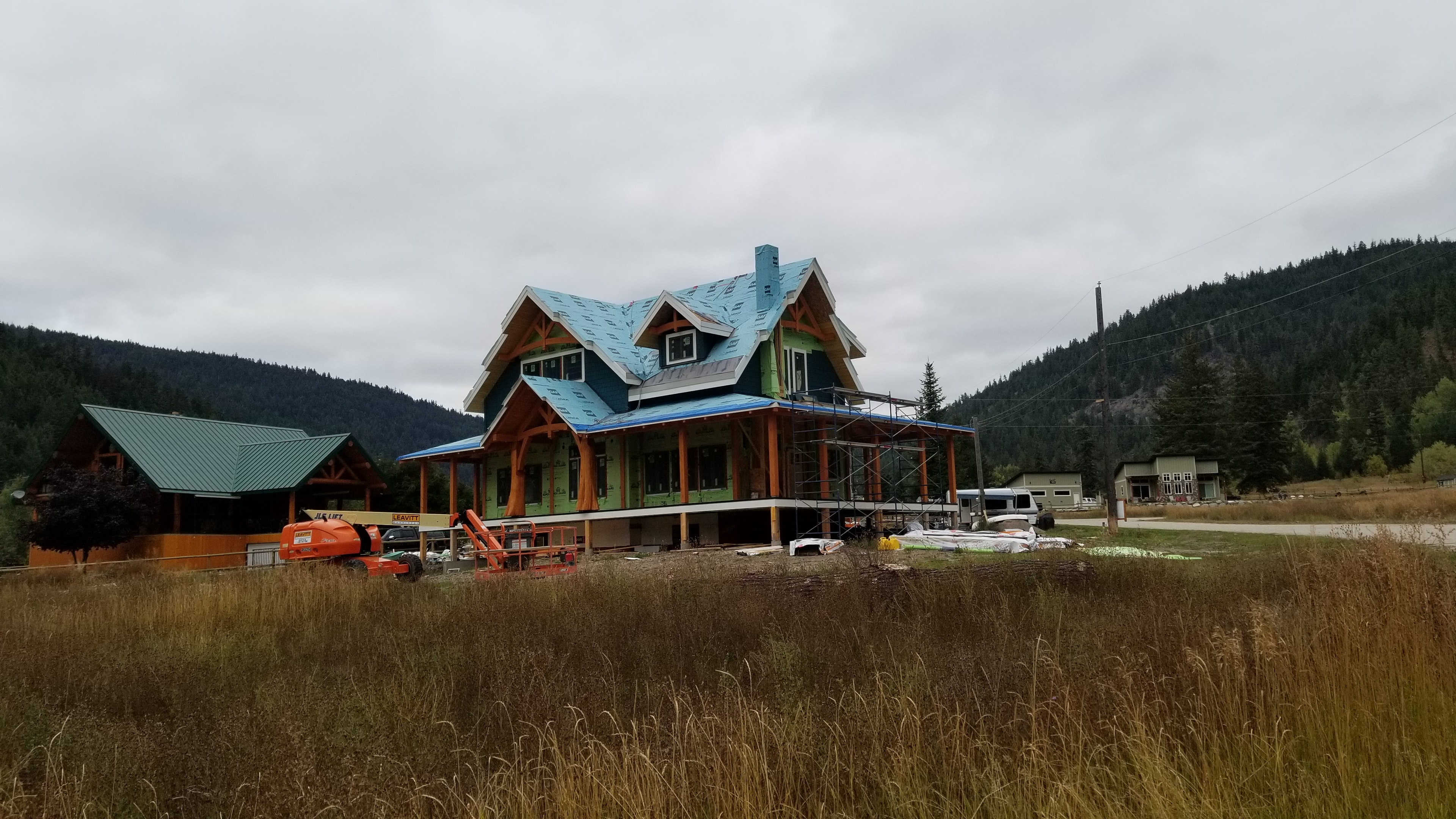 Allison Lake Residence — wide view of construction with mountain backdrop